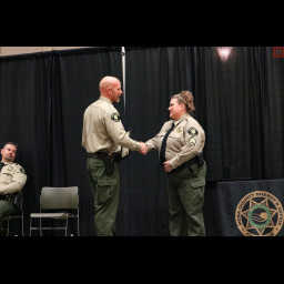 Sergeant Christi Montez accepts an award from Sheriff Todd Rowell.