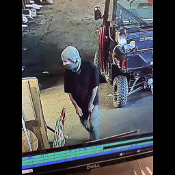 Man with a mask standing in a garage