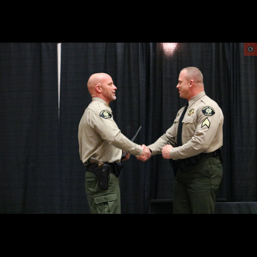Sergeant Justin Montover accepts an award from Sheriff Todd Rowell.