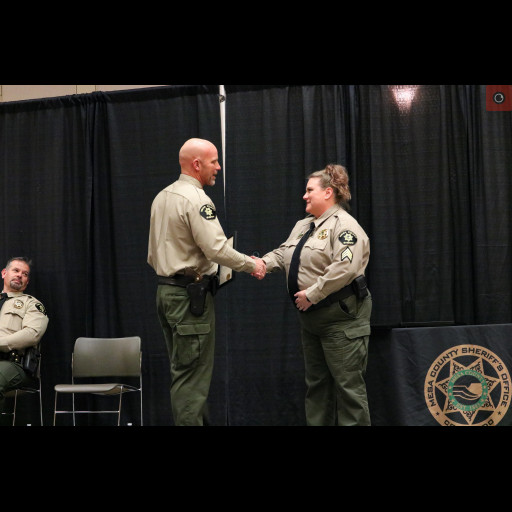 Sergeant Christi Montez accepts an award from Sheriff Todd Rowell.