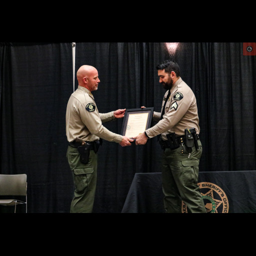 Mesa County Sheriff Todd Rowell presents award to Sergeant Ryan Morrison.