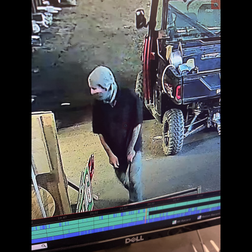 Man with a mask standing in a garage